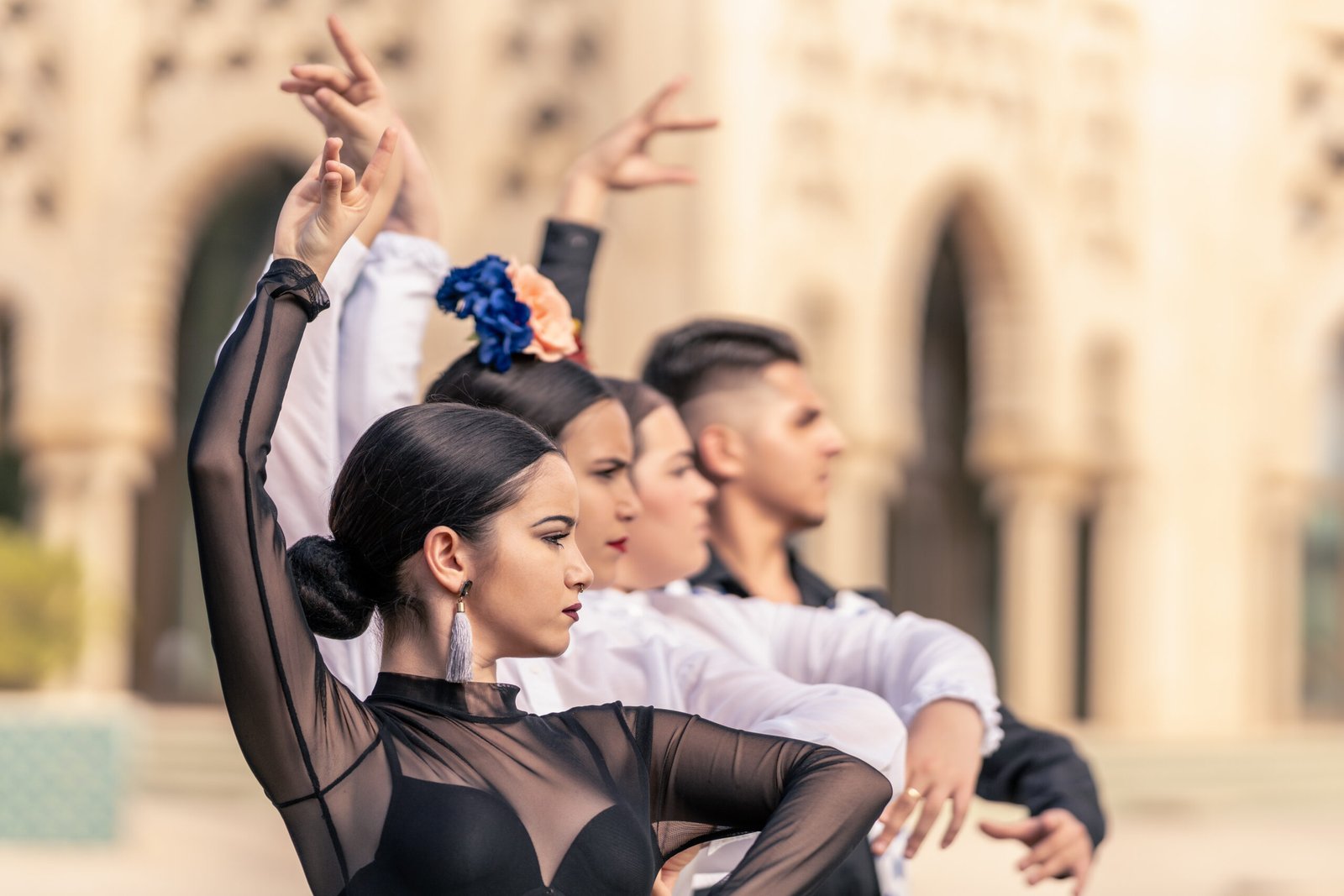 Medium shot of a group of students from a flamenco school learning how to pose